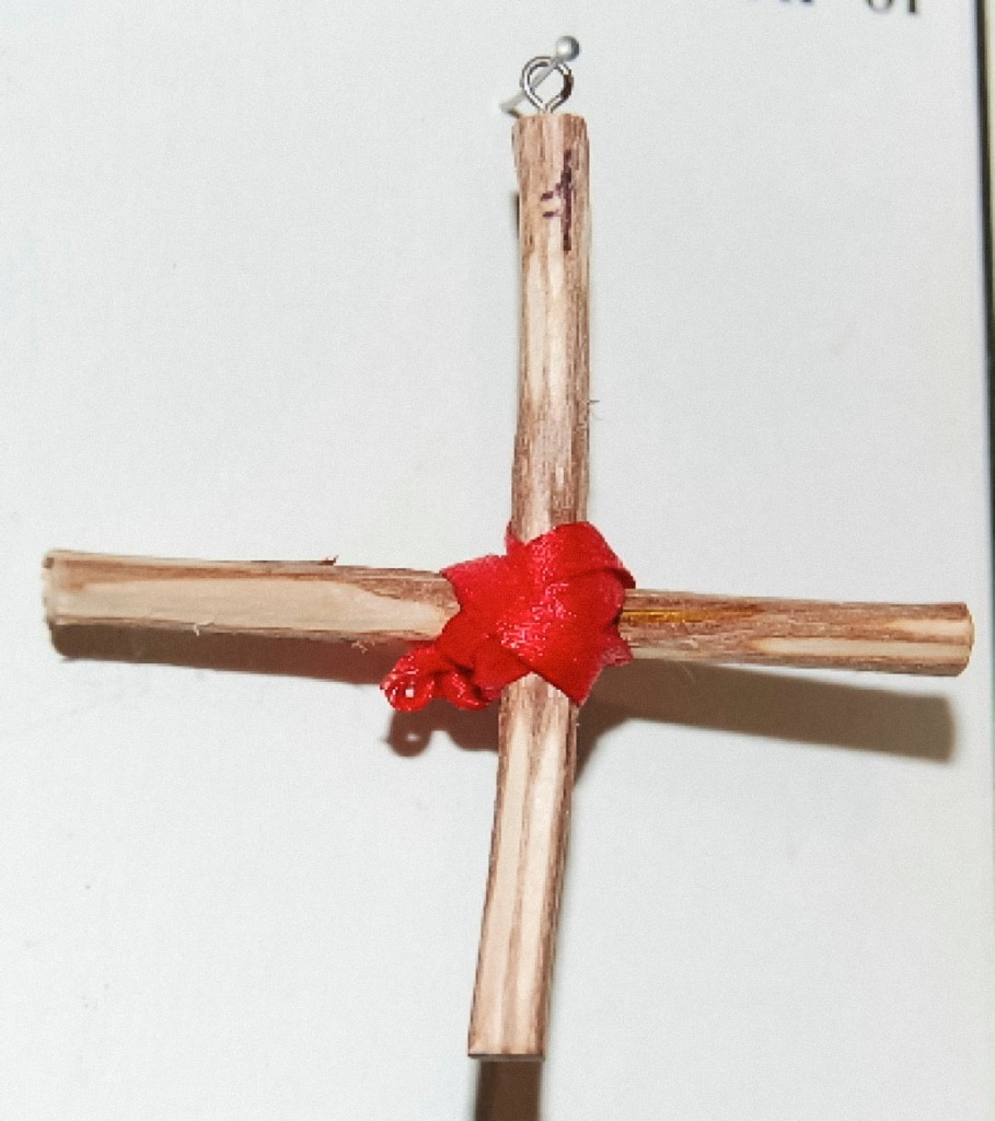 Rowan Cross, two wood sticks ina  cross formation, bound with red threads at the junction.
